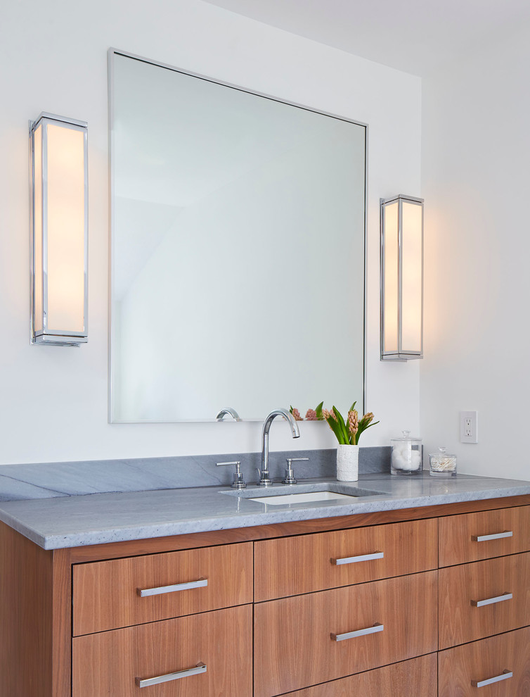 Mid-sized scandinavian master bathroom in Minneapolis with flat-panel cabinets, medium wood cabinets, white walls, an undermount sink, a freestanding tub, a corner shower, a two-piece toilet, white tile, marble, marble floors, marble benchtops, white floor and a hinged shower door.