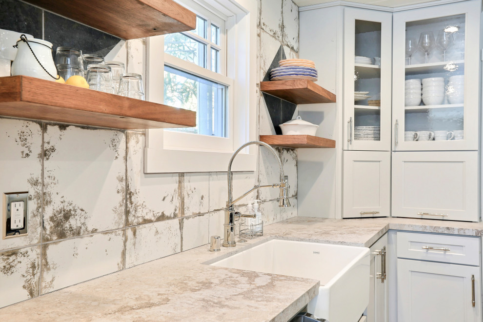 Photo of a mid-sized eclectic l-shaped eat-in kitchen in San Francisco with a farmhouse sink, shaker cabinets, quartz benchtops, white splashback, porcelain splashback, coloured appliances, light hardwood floors, with island, grey benchtop and timber.