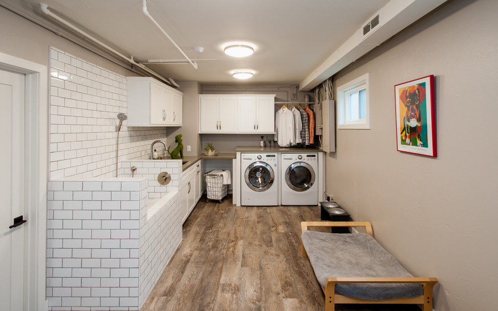 Transitional l-shaped utility room in Seattle with an undermount sink, shaker cabinets, white cabinets, quartz benchtops, grey walls, vinyl floors and a side-by-side washer and dryer.