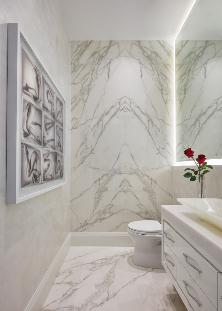 This is an example of a contemporary powder room in Miami with white cabinets, flat-panel cabinets, white tile, a vessel sink, white floor, white benchtops and a floating vanity.