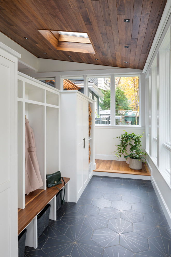 Inspiration for a mid-sized transitional mudroom in Boston with a single front door, beige walls and grey floor.
