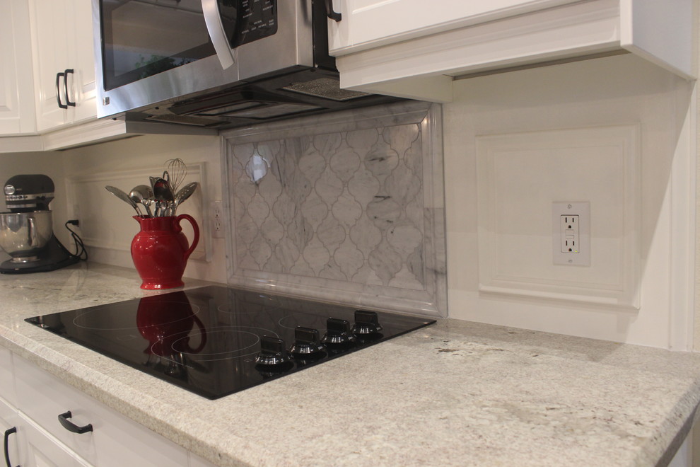 Inspiration for a mid-sized transitional u-shaped ceramic tile enclosed kitchen remodel in Phoenix with a double-bowl sink, raised-panel cabinets, white cabinets, marble countertops, gray backsplash, ceramic backsplash, stainless steel appliances and an island