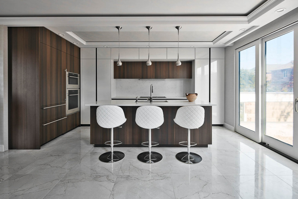 Mid-sized contemporary l-shaped eat-in kitchen in New York with an undermount sink, flat-panel cabinets, dark wood cabinets, quartz benchtops, stone slab splashback, panelled appliances, porcelain floors, with island, white floor, white splashback and white benchtop.