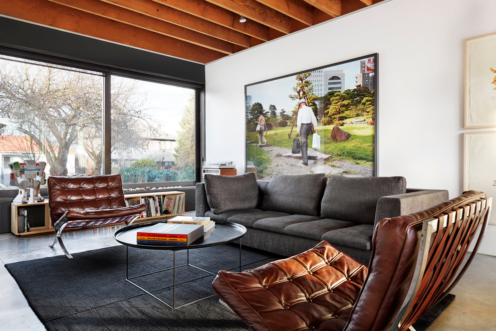 This is an example of a contemporary formal open concept living room in Vancouver with white walls.