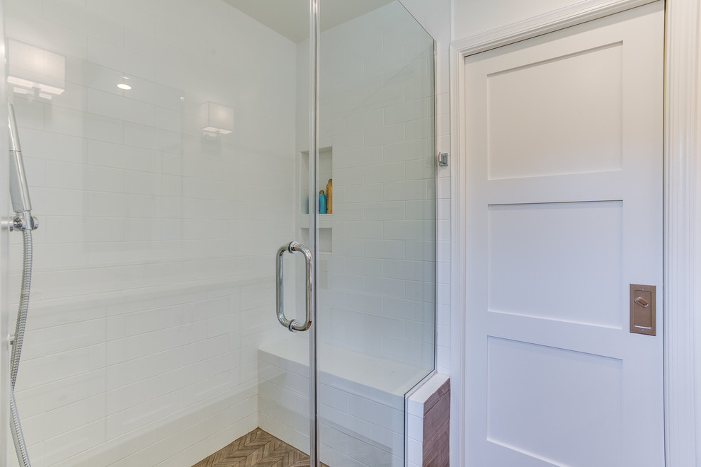 Design ideas for a mid-sized transitional master bathroom in DC Metro with shaker cabinets, white cabinets, an alcove shower, white walls, medium hardwood floors, an undermount sink, marble benchtops and a hinged shower door.