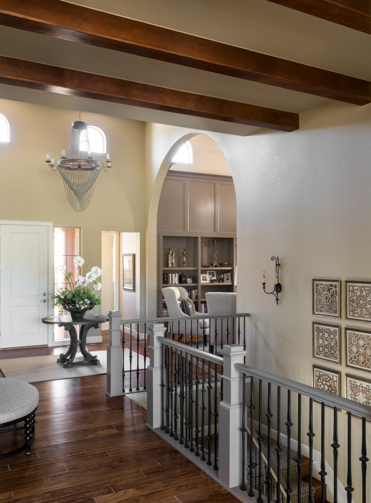 Example of a transitional exposed beam hallway design in Denver with beige walls
