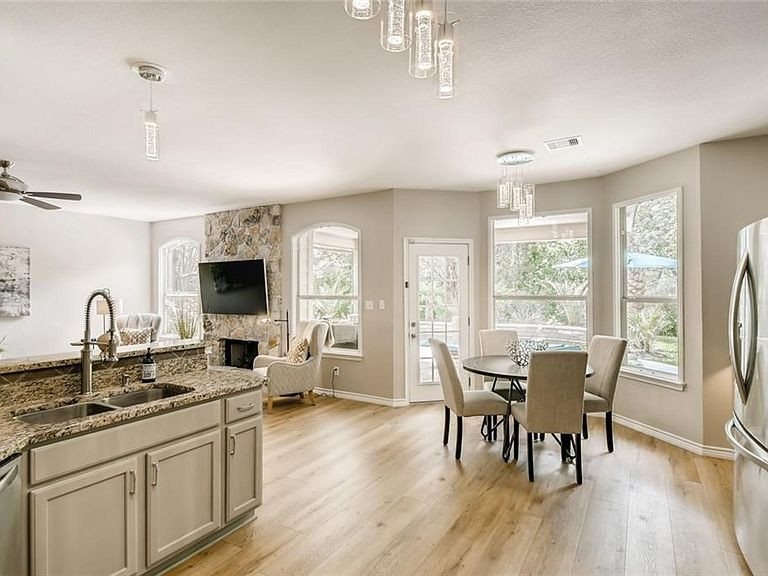 This is an example of a large traditional kitchen/diner in Austin with a double-bowl sink, shaker cabinets, grey cabinets, granite worktops, beige splashback, ceramic splashback, stainless steel appliances, vinyl flooring, beige floors and multicoloured worktops.