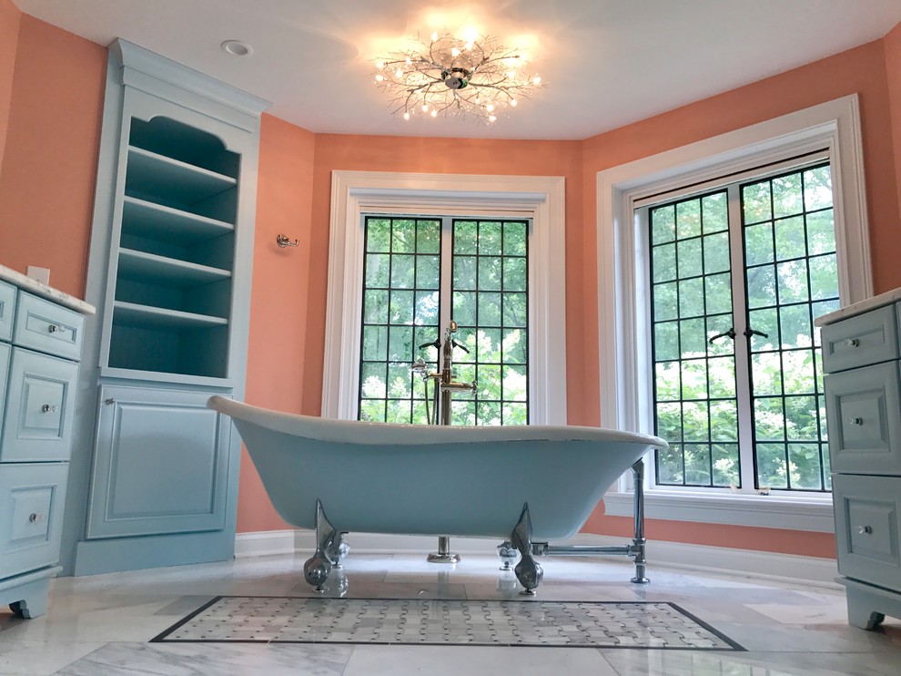 Large master gray tile and marble tile marble floor and gray floor freestanding bathtub photo with raised-panel cabinets, turquoise cabinets, a two-piece toilet, pink walls, an undermount sink, granite countertops and a hinged shower door