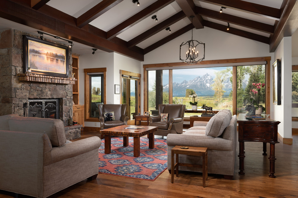 Inspiration for a country open concept living room in Other with white walls, medium hardwood floors, a standard fireplace, a stone fireplace surround and brown floor.
