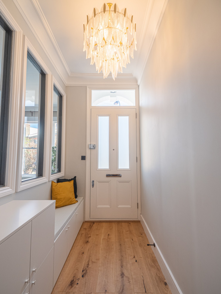 Photo of a mid-sized traditional entryway in London with beige walls and beige floor.