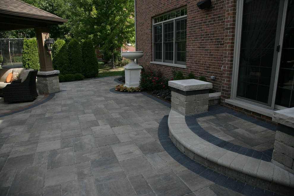 Design ideas for a large traditional backyard patio in Chicago with an outdoor kitchen, brick pavers and a pergola.