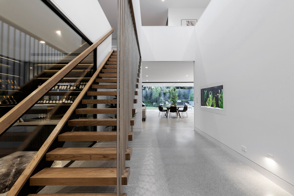 This is an example of a contemporary wood staircase in Melbourne with wood railing and wood risers.