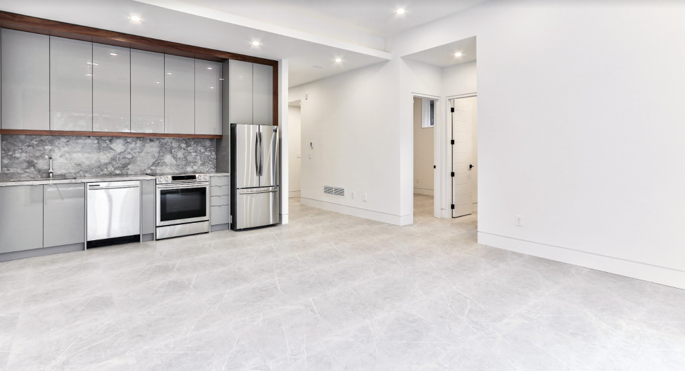 Photo of a large classic walk-out basement in Toronto with a home bar, white walls, ceramic flooring, a corner fireplace, a tiled fireplace surround, grey floors, a drop ceiling and wallpapered walls.