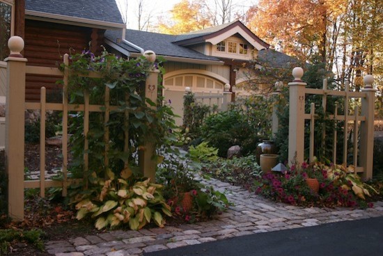 This is an example of a large traditional full sun front yard stone landscaping.