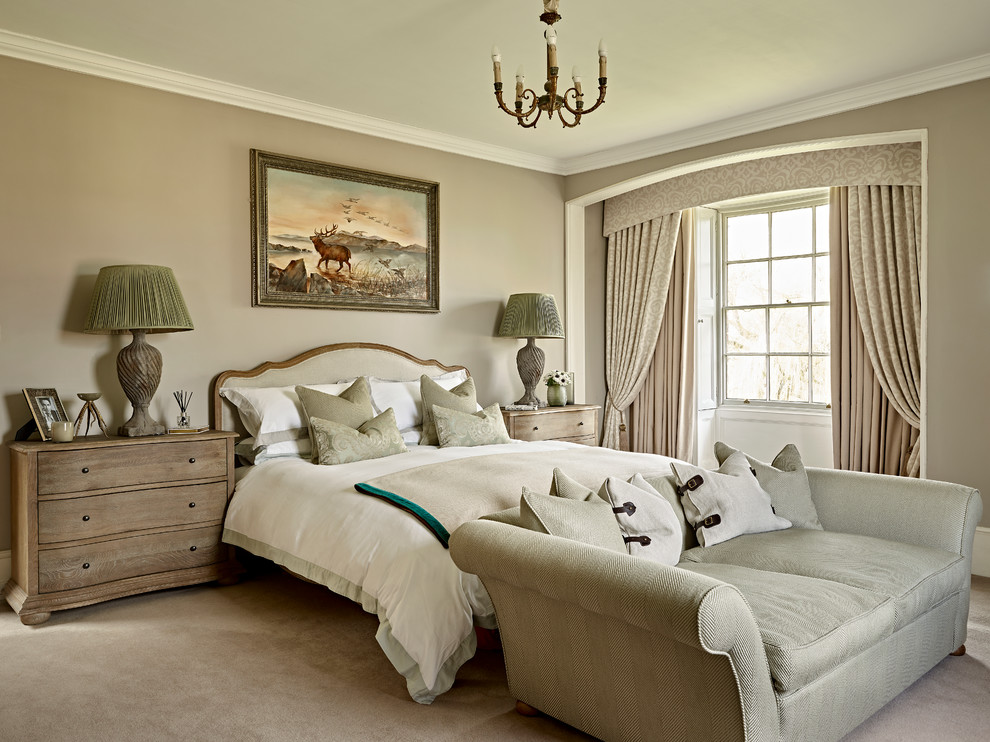 Photo of a mid-sized traditional bedroom in London with beige walls, carpet and beige floor.