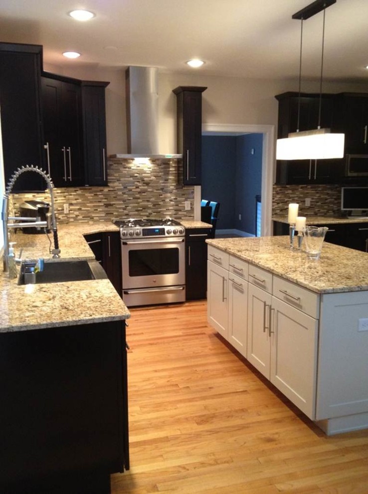 Eat-in kitchen - large transitional light wood floor eat-in kitchen idea in Chicago with shaker cabinets, dark wood cabinets, quartzite countertops, stainless steel appliances, beige walls and an island