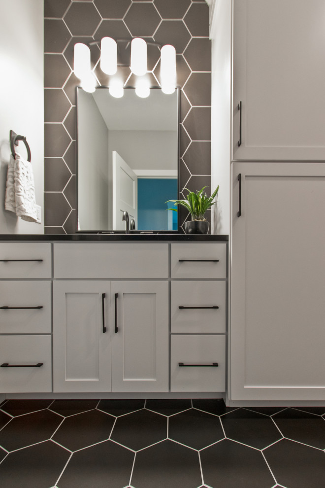 Transitional porcelain tile and black floor doorless shower photo with recessed-panel cabinets, white cabinets, a two-piece toilet, white walls, quartz countertops, black countertops and a built-in vanity