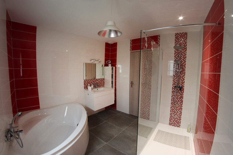 This is an example of an expansive industrial master bathroom in Nantes with a corner tub, a curbless shower, red tile, mosaic tile, white walls, ceramic floors, an undermount sink, grey floor and white benchtops.