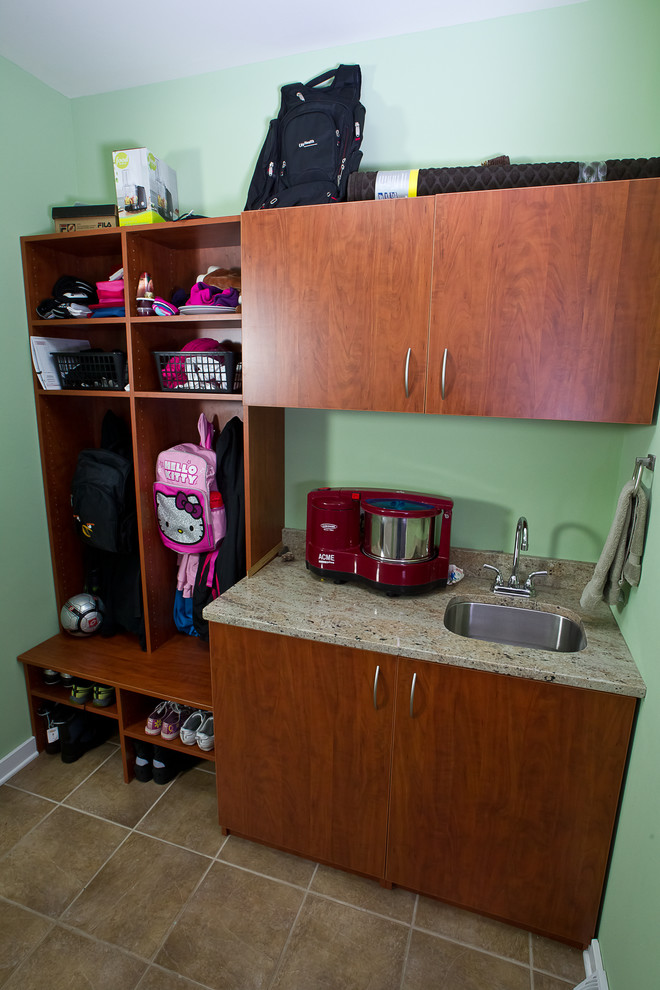 This is an example of a small transitional dedicated laundry room in Other with an undermount sink, flat-panel cabinets, medium wood cabinets, granite benchtops, green walls and ceramic floors.