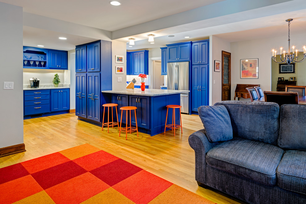 Kitchen - transitional light wood floor kitchen idea in Columbus with an undermount sink, recessed-panel cabinets, blue cabinets, marble countertops, white backsplash and stainless steel appliances