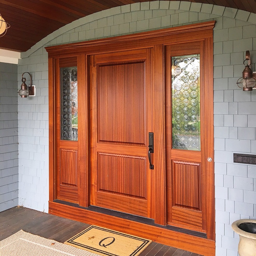 Traditional front door in New York with a single front door and a medium wood front door.