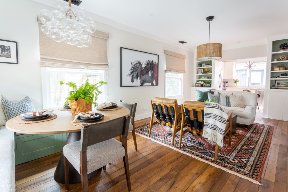 Photo of a small transitional dining room in Santa Barbara with white walls, dark hardwood floors and brown floor.