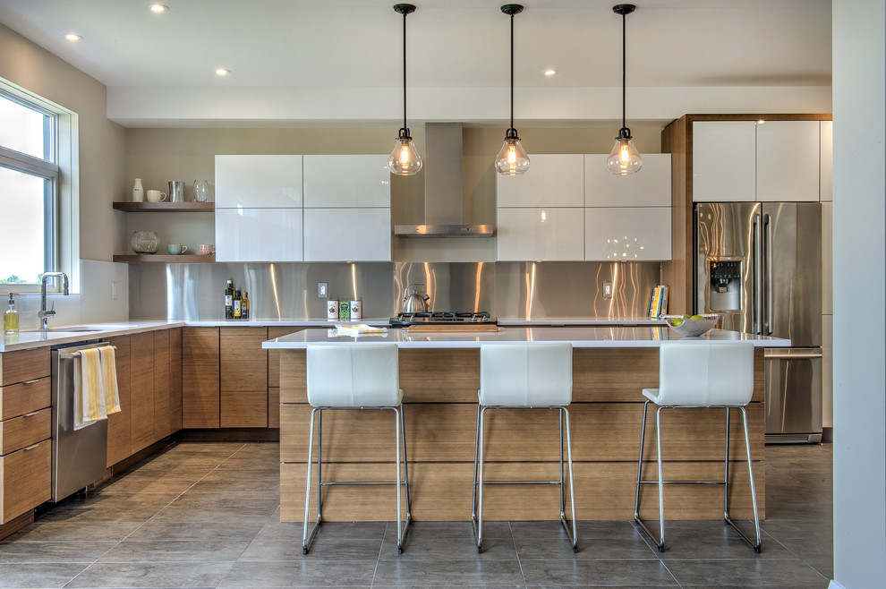 Design ideas for a contemporary l-shaped kitchen in Toronto with an undermount sink, flat-panel cabinets, white cabinets, metallic splashback, stainless steel appliances and with island.