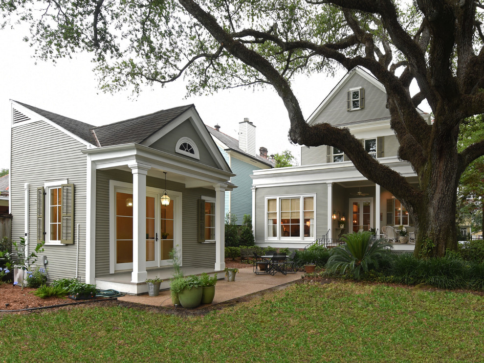 Design ideas for a mid-sized traditional two-storey grey house exterior in New Orleans with wood siding and a gable roof.