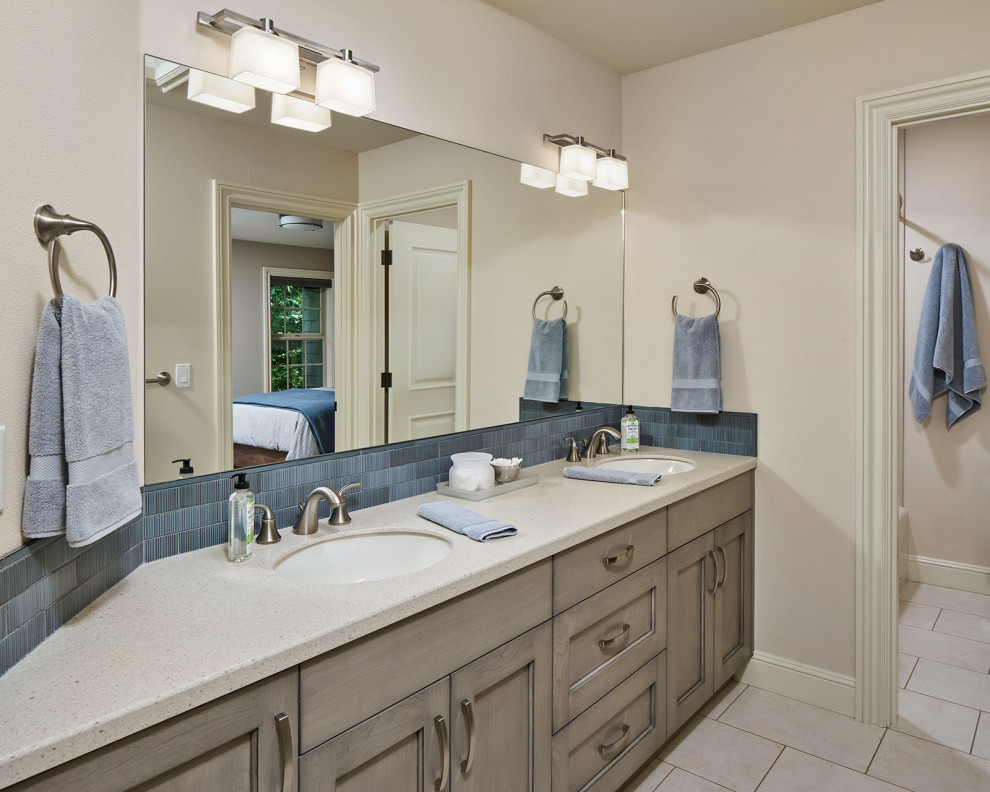 Example of a mid-sized transitional kids' blue tile and ceramic tile porcelain tile, beige floor and double-sink bathroom design in Portland with recessed-panel cabinets, gray cabinets, an undermount sink, solid surface countertops, beige countertops and a built-in vanity