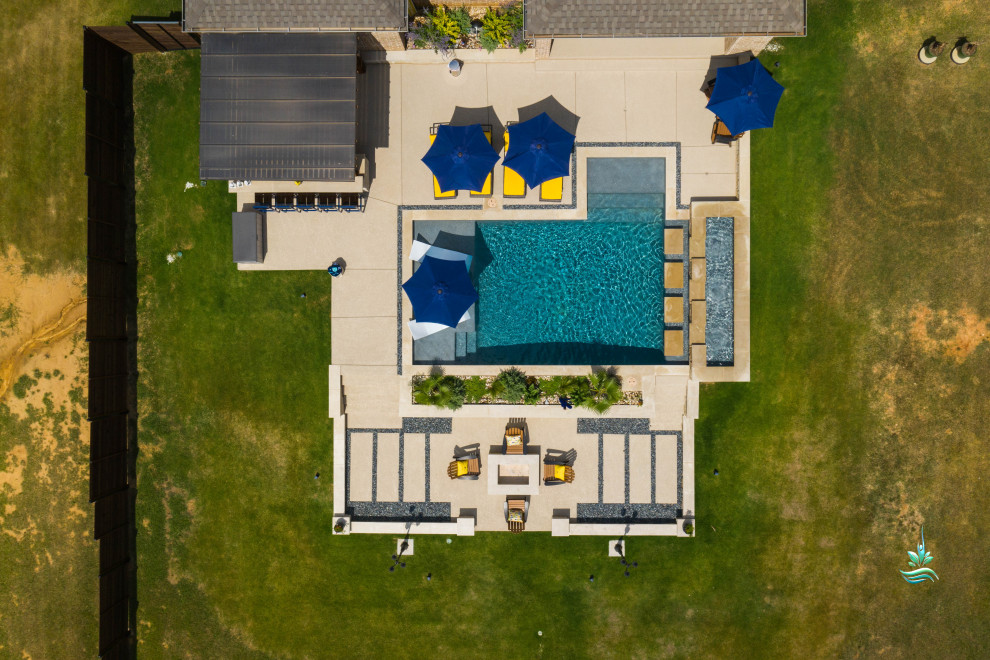 Example of a huge tuscan backyard custom-shaped infinity pool landscaping design in Dallas with decking