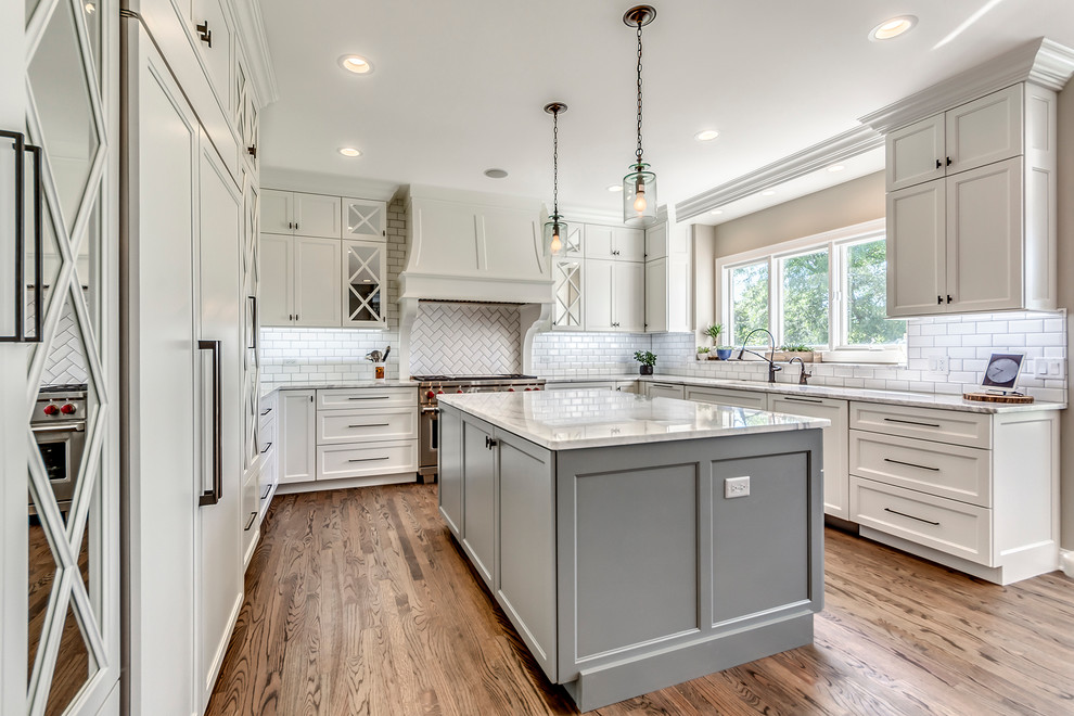 Inspiration for a transitional open concept kitchen remodel in Chicago with white backsplash, subway tile backsplash and two islands