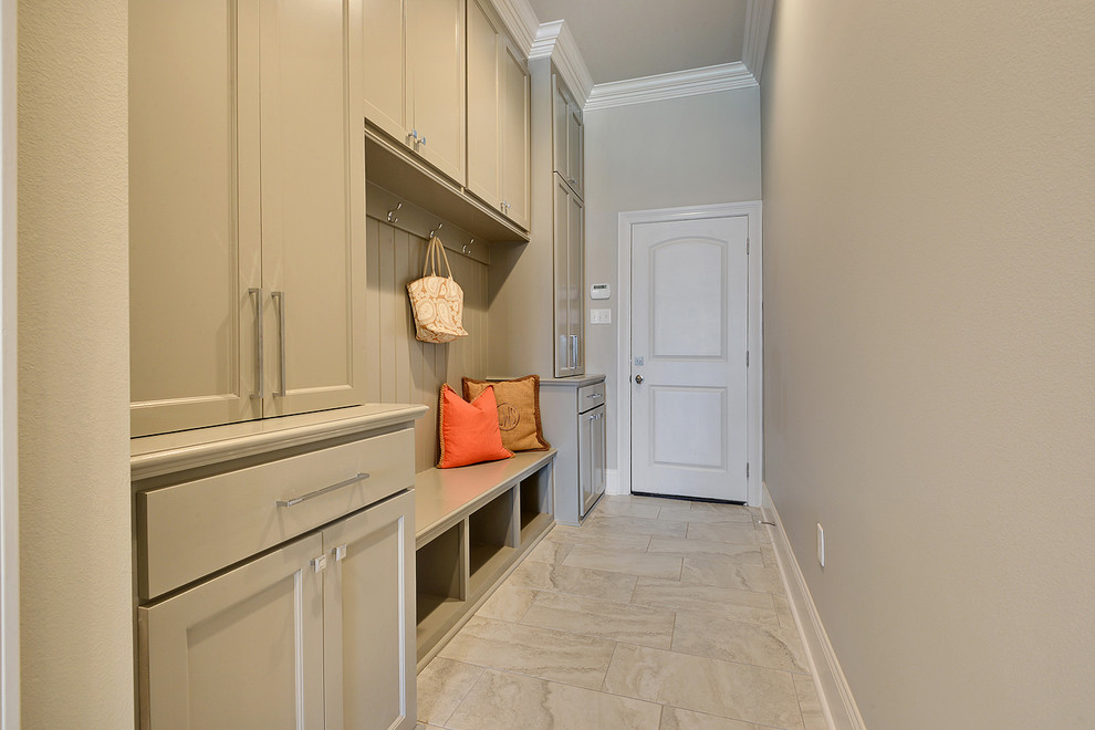 Large traditional mudroom in New Orleans with grey walls, porcelain floors, a single front door and a white front door.