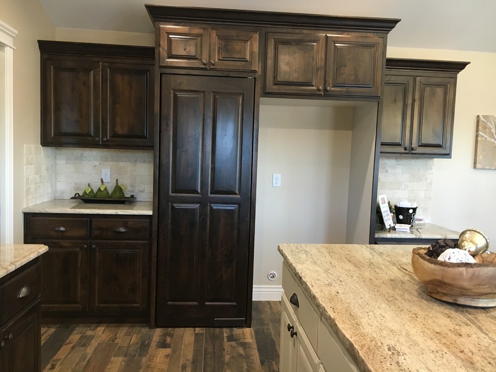 Example of a large transitional u-shaped porcelain tile open concept kitchen design with an undermount sink, raised-panel cabinets, dark wood cabinets, granite countertops, beige backsplash, stone tile backsplash, stainless steel appliances and an island