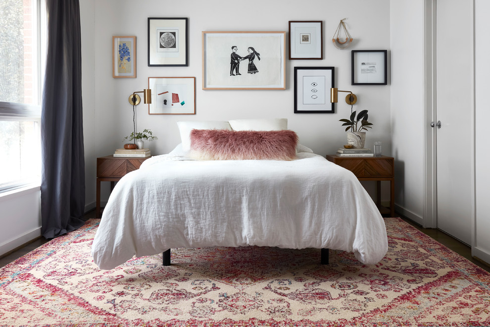 Inspiration for an eclectic bedroom in Dallas with white walls, dark hardwood floors and no fireplace.