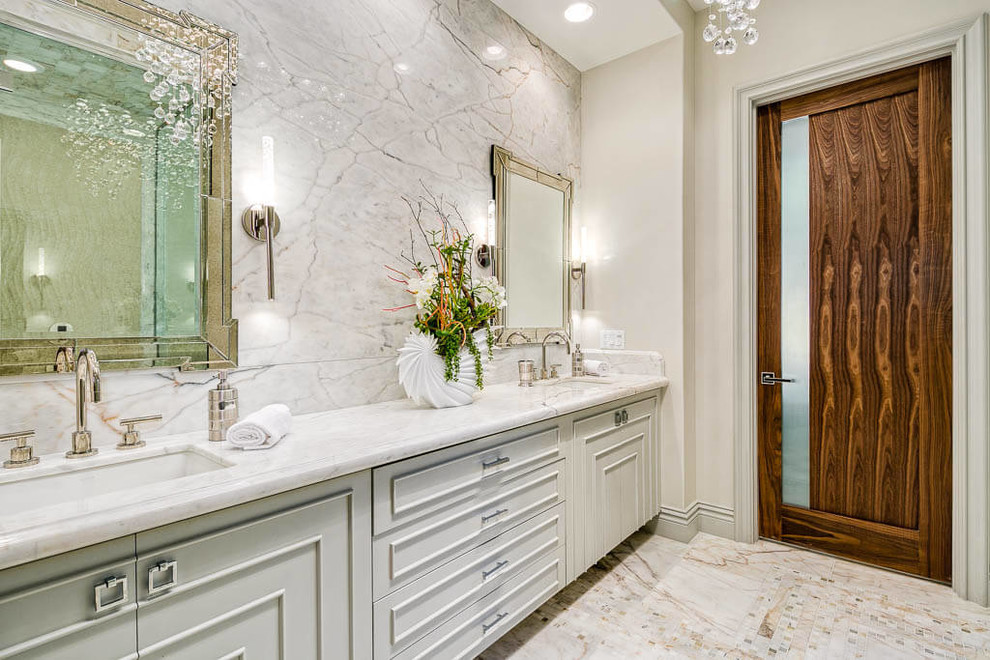 This is an example of a traditional master bathroom in Los Angeles with grey cabinets, beige walls and an undermount sink.
