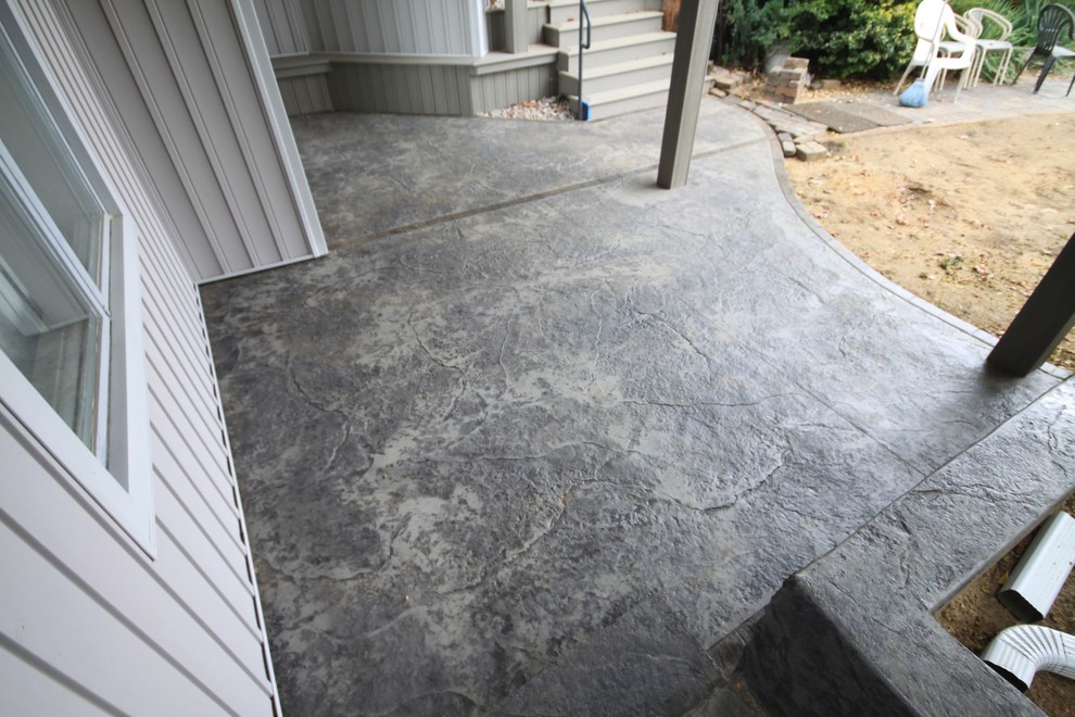 This is an example of a mid-sized beach style patio in Other with stamped concrete.