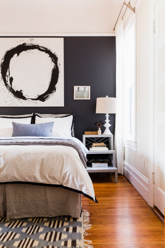 Inspiration for a transitional master bedroom in San Francisco with black walls and medium hardwood floors.