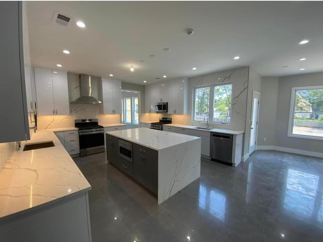 Large minimalist galley porcelain tile, gray floor and wood ceiling eat-in kitchen photo in Toronto with flat-panel cabinets, white cabinets, wood countertops, beige backsplash and white countertops