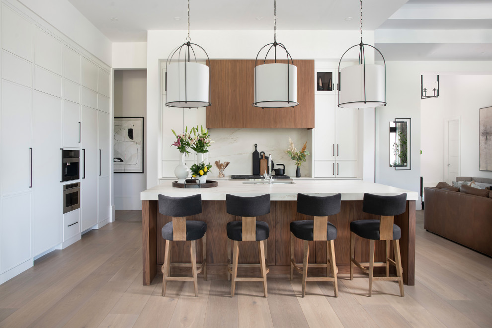 Inspiration for a large coastal eat-in kitchen remodel with white cabinets, marble countertops, white backsplash, marble backsplash, an island and white countertops