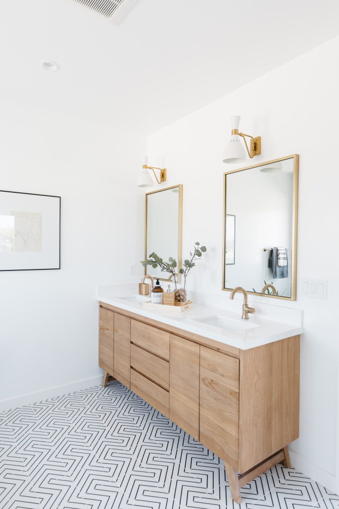 Example of a large farmhouse 3/4 porcelain tile, multicolored floor and double-sink bathroom design in Los Angeles with flat-panel cabinets, light wood cabinets, white walls, an undermount sink, white countertops and a freestanding vanity