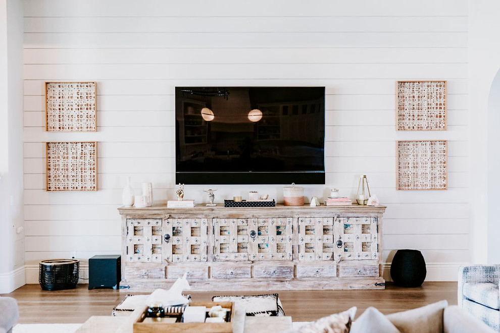 Inspiration for a large contemporary formal open concept living room in Phoenix with white walls, light hardwood floors, a corner fireplace, a wood fireplace surround, a wall-mounted tv and beige floor.