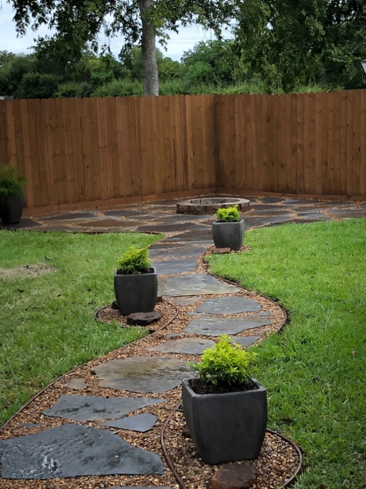 Backyard flagstone walking path with firepit and seating area
