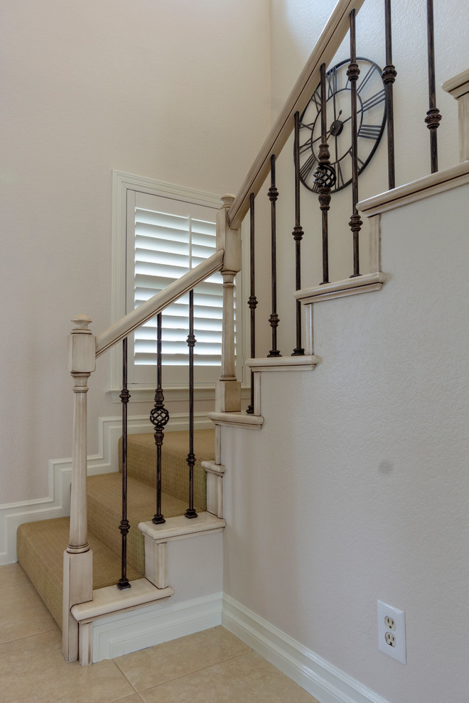 Small mediterranean painted wood l-shaped staircase in Orange County with painted wood risers and mixed railing.