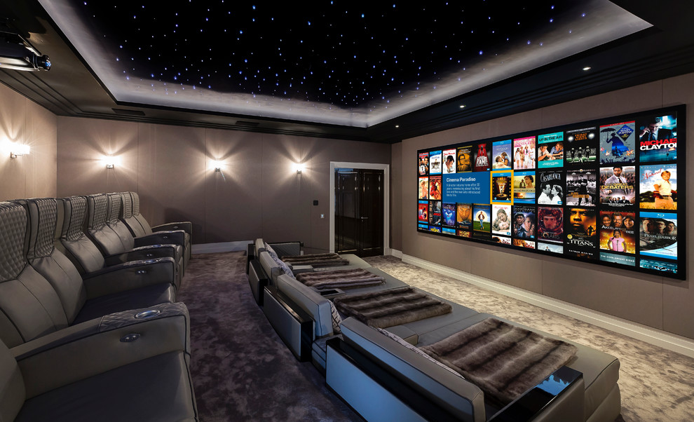 Large contemporary enclosed home theatre in Berkshire with brown walls, carpet and a projector screen.