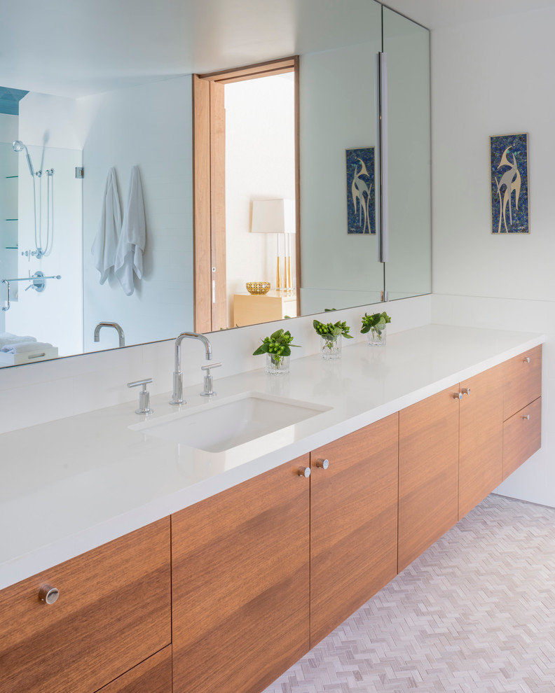 Photo of a mid-sized contemporary master bathroom in Los Angeles with flat-panel cabinets, medium wood cabinets, white walls, marble floors, an undermount sink, engineered quartz benchtops and grey floor.