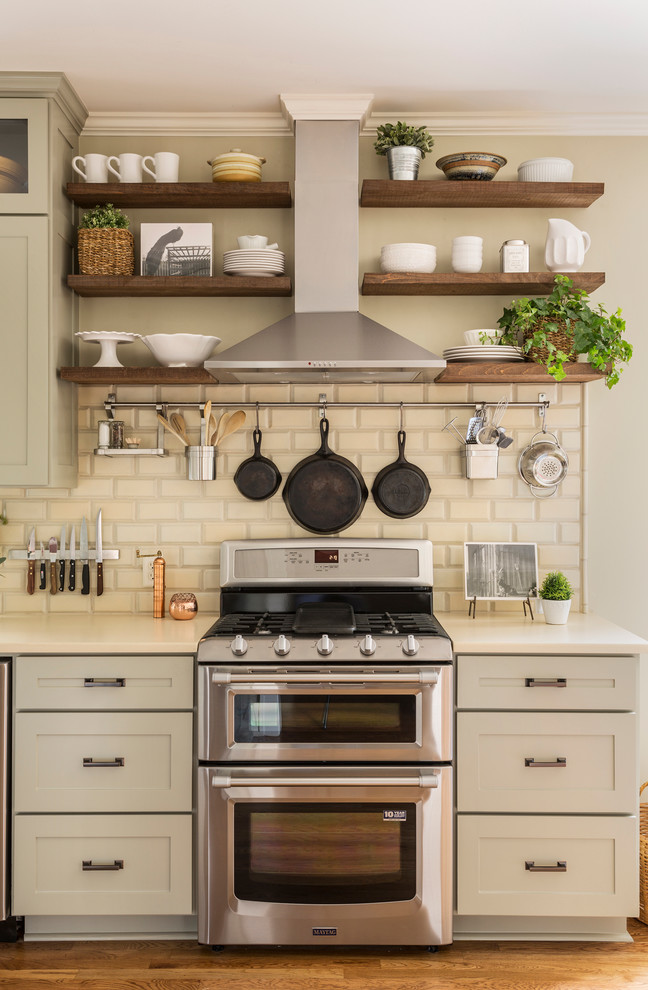 Inspiration for a mid-sized eclectic kitchen in Little Rock with a farmhouse sink, shaker cabinets, grey cabinets, quartzite benchtops, beige splashback, terra-cotta splashback, stainless steel appliances, medium hardwood floors and no island.