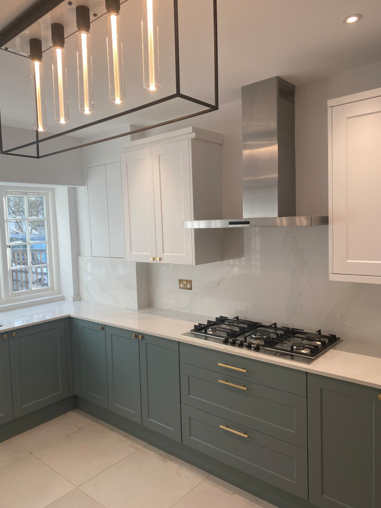 This is an example of a large contemporary galley eat-in kitchen in London with quartzite benchtops, white splashback, porcelain floors and no island.