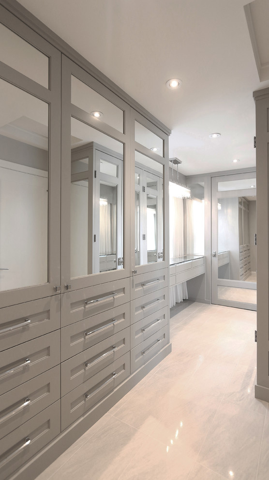 Inspiration for a large contemporary gender-neutral walk-in wardrobe in Calgary with beaded inset cabinets, grey cabinets, porcelain floors and beige floor.