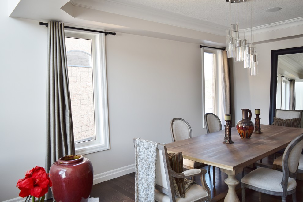 Example of a mid-sized transitional dark wood floor and brown floor great room design in Toronto with white walls and no fireplace