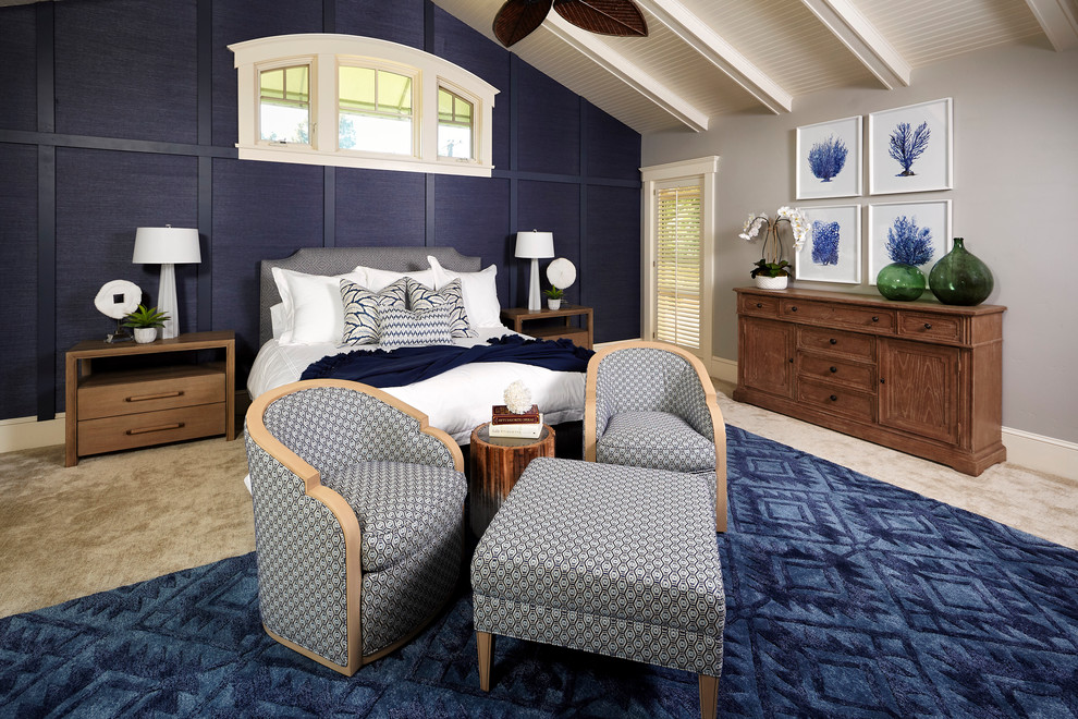 Inspiration for a large beach style master bedroom in San Diego with blue walls, carpet, a standard fireplace, a wood fireplace surround and beige floor.